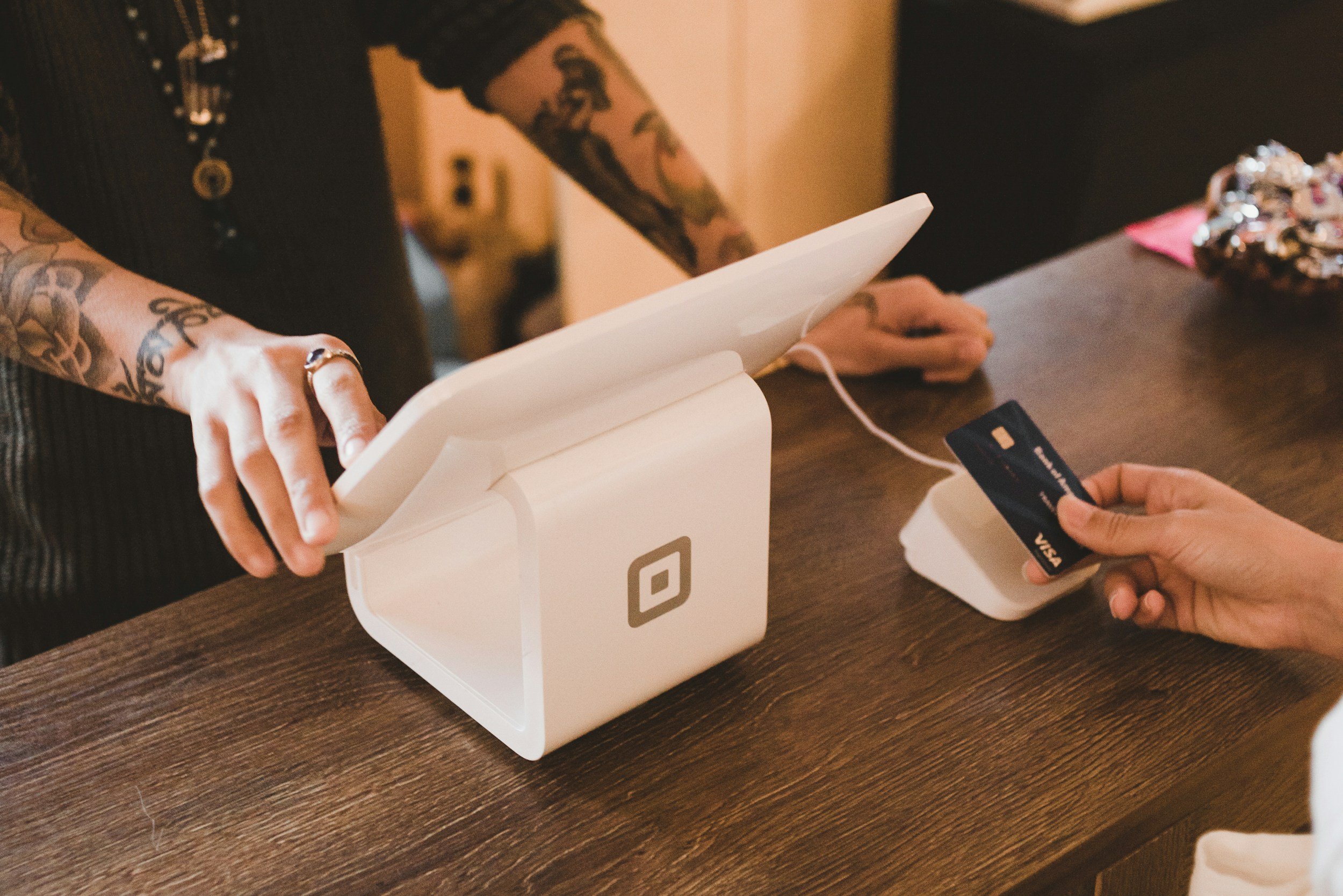 A person taking card payment from a customer.